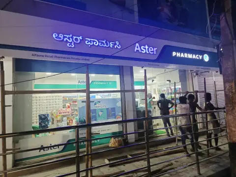 Aster Pharmacy storefront signage in Kannada and English