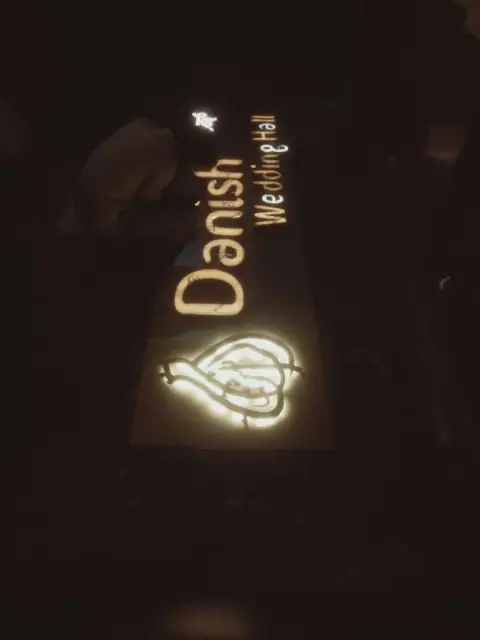 Illuminated logo and letters for a wedding hall at night